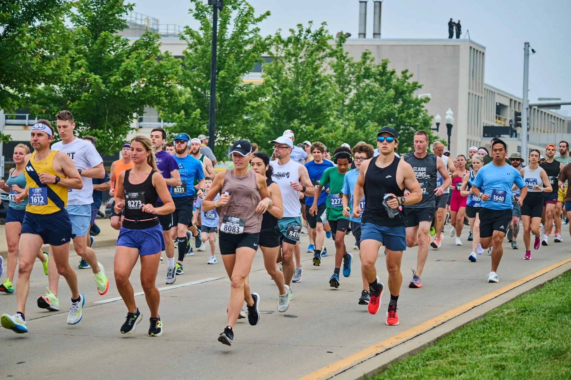 Lead pack of runners racing through a city street